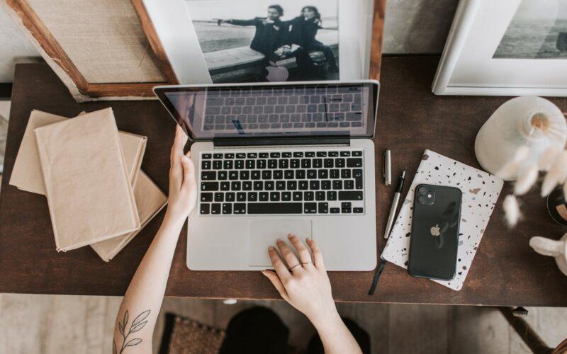 unrecognizable lady using laptop in workspace
