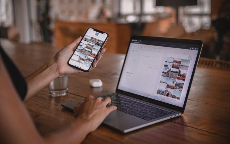 woman using smartphone and laptop