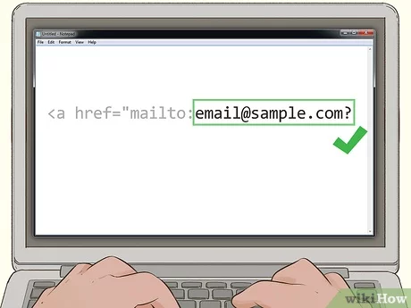 Cómo crear un enlace mailto con HTML --Una persona escribiendo en una computadora portátil creando una dirección de correo electrónico.